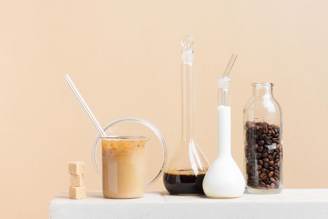 Coffee making laboratory with brewed coffee, beans, milk and sugar cubes