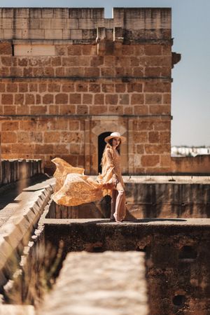 Stylish female on old bridge