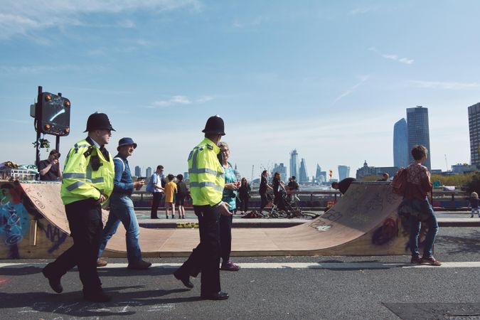 London, England, United Kingdom - April 19th, 2019: Police walk past a half pipe overlooking London