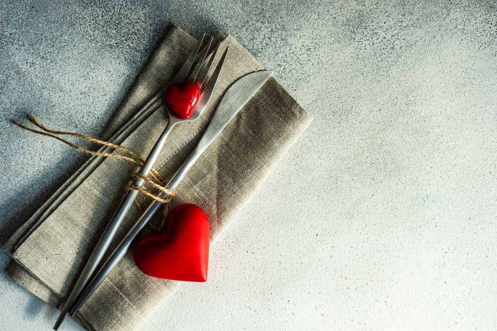 St. Valentine day card with napkin, silverware and heart decorations