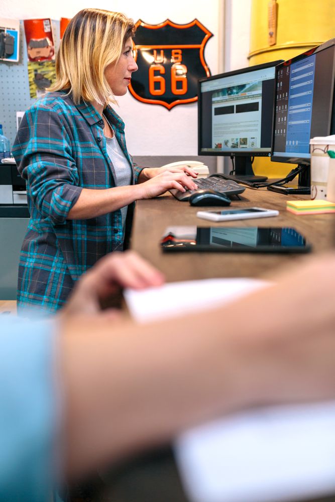 Blonde young woman checking orders received by ecommerce shop