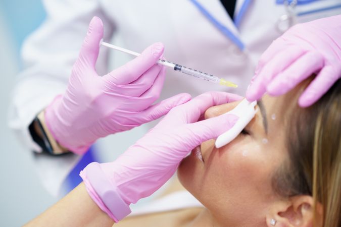 Woman having botox treatment on face in medical spa
