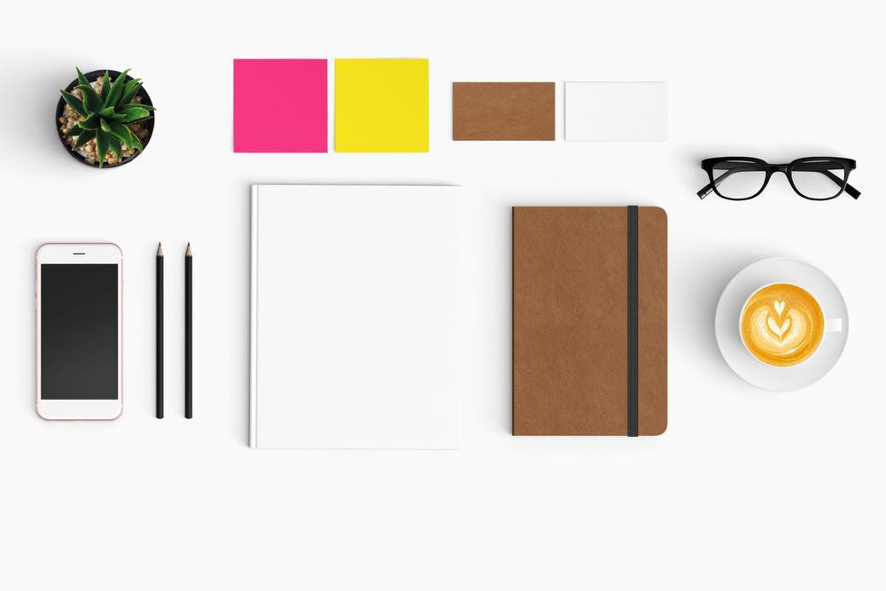 Modern workspace with coffee cup, smartphone, paper, notebook, tablet copy space