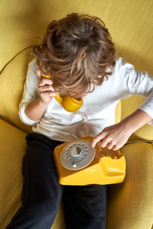 Boy having conversation on landline telephone