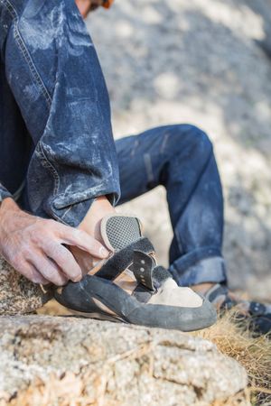 A rock climber is preparing to start climbing