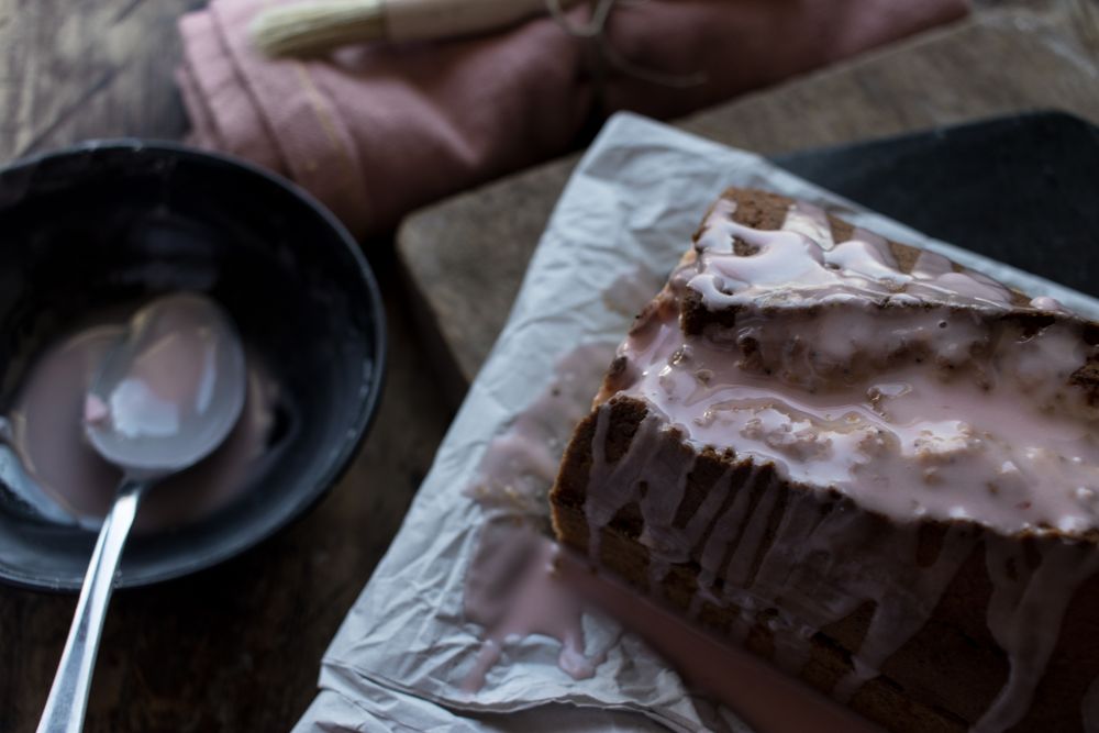 spoon pouring creme on delicious orange cake