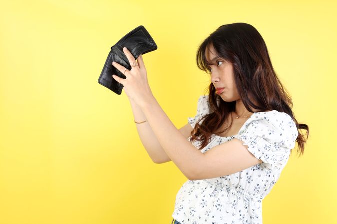 Unhappy Young Asian Woman Open Her Empty Wallet