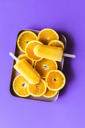 Orange ice cream popsicles on a tray