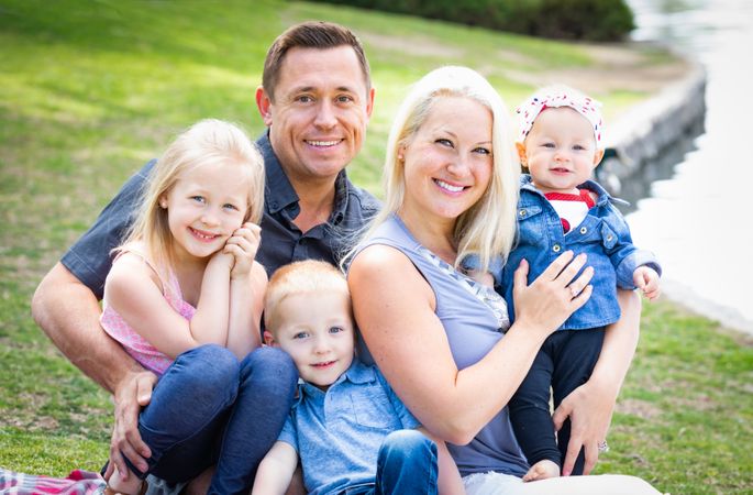 Happy Young Family Portrait In The Park