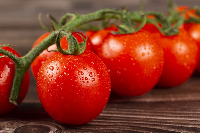 Ripe tomatoes on the wooden table.
