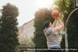 Streetball player playing on outdoor court 5RVdgr