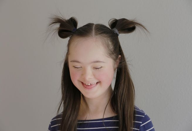 Portrait of a little child looking down and smiling