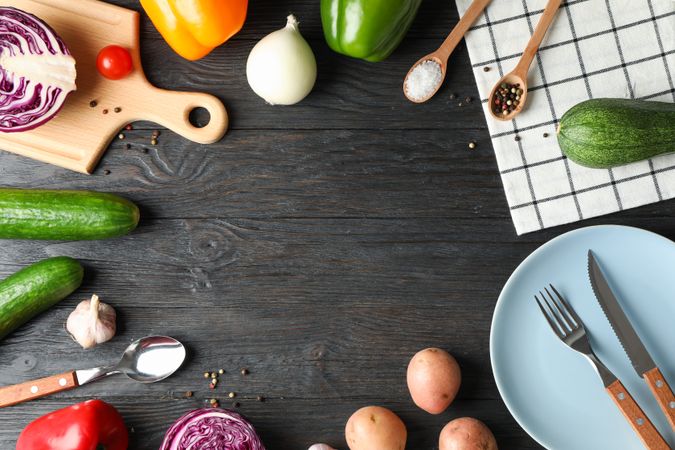 Kitchen supplies, vegetables and spices on wooden background, copy space