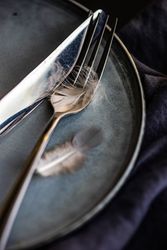Close up of silverware with feather decoration