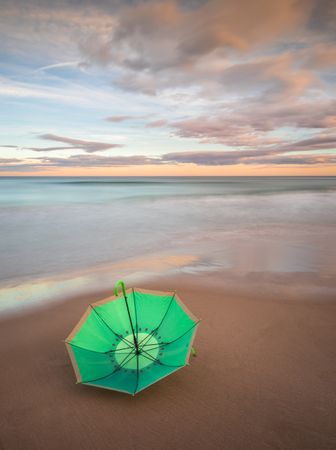 Umbrella on beach near sea