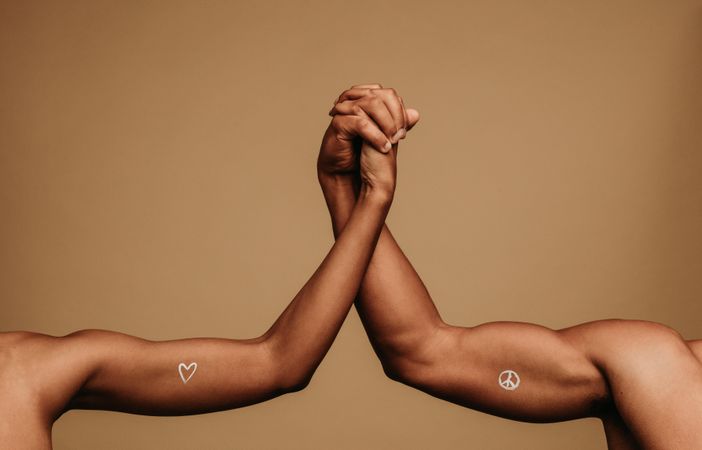 Close up of hands of man and woman holding each other showing unity and togetherness