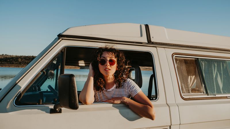 Smiling woman sitting in retro car