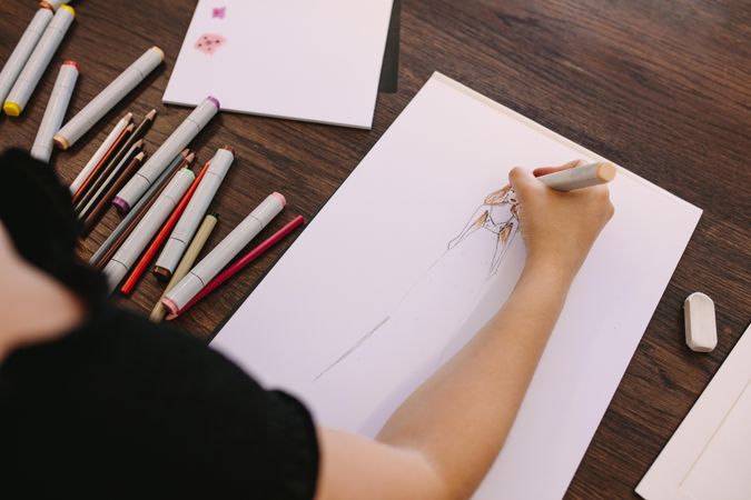 Female entrepreneur sketching a design at her table