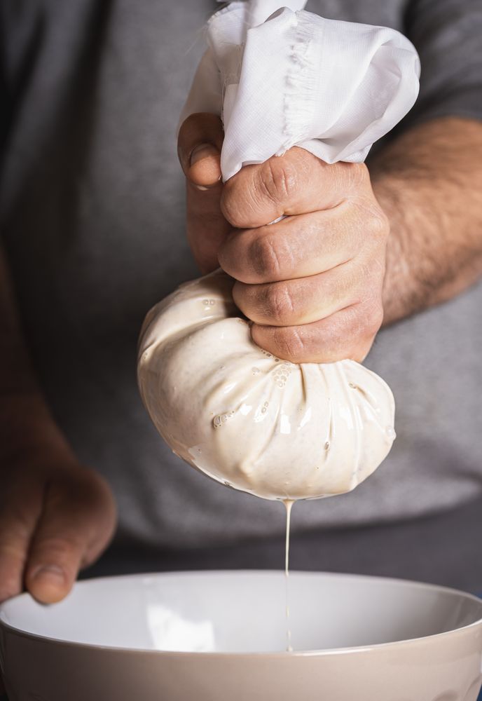 Man squeezing rice through cloth for horchata