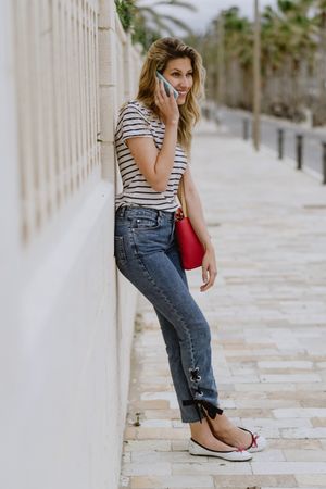 Woman using phone on city street