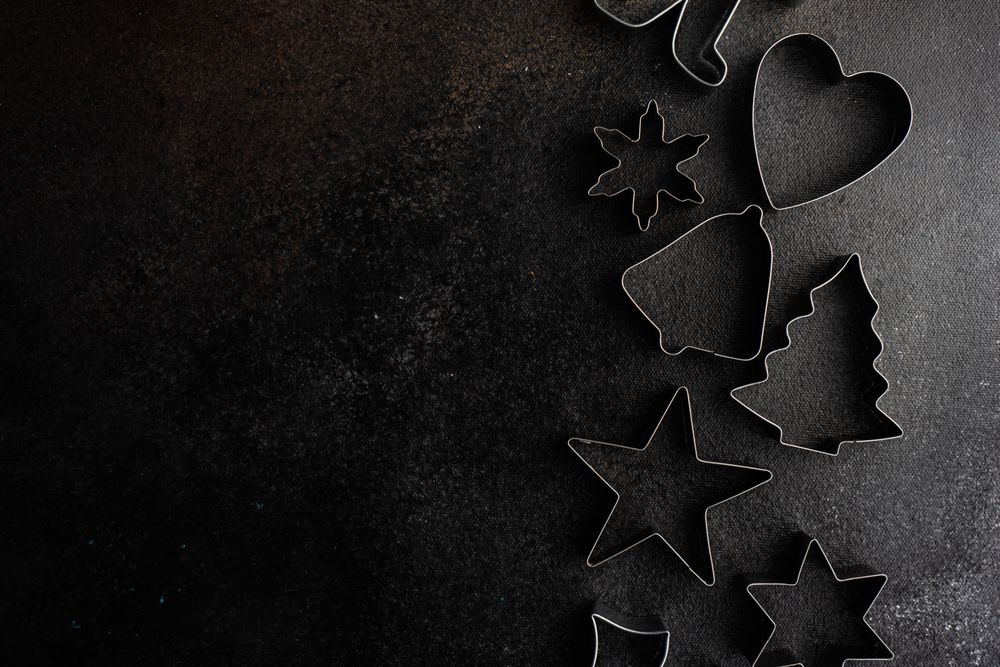 Christmas cookie cutters on dark background