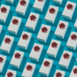 Pattern made of gift boxes on blue background