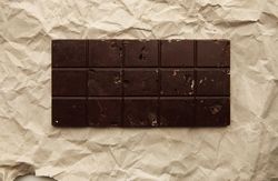 Block of artisan chocolate on craft paper
