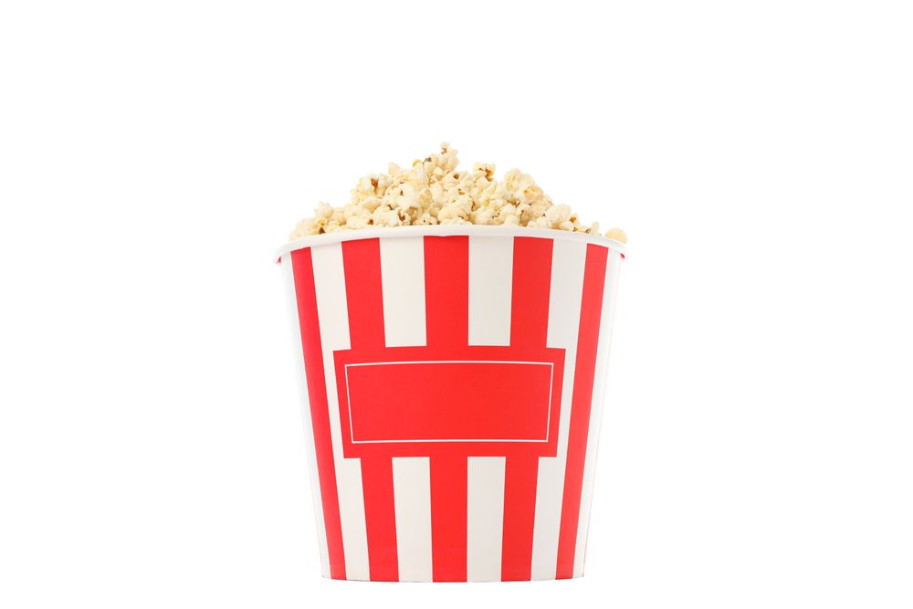 Striped bucket with popcorn isolated on plain background