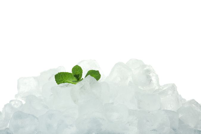 Heap of ice with mint leaves on blank background