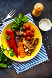 Plate of grilled vegetable on striped blue napkin with copy space