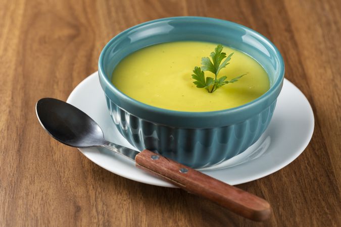 Bowl with onion soup and croutons on the table.