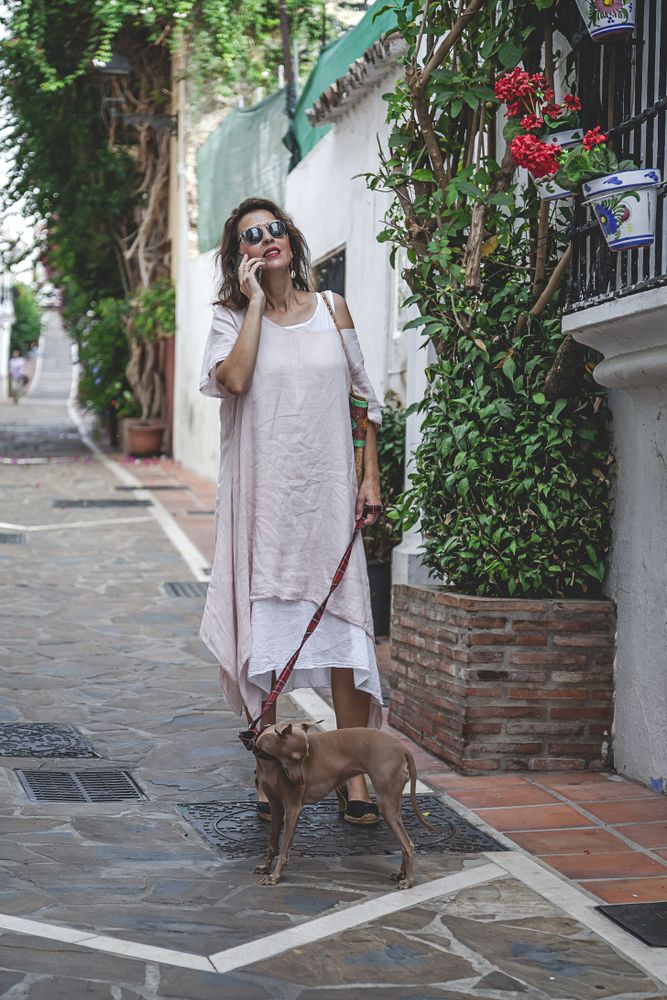 Woman walking with dog on the street