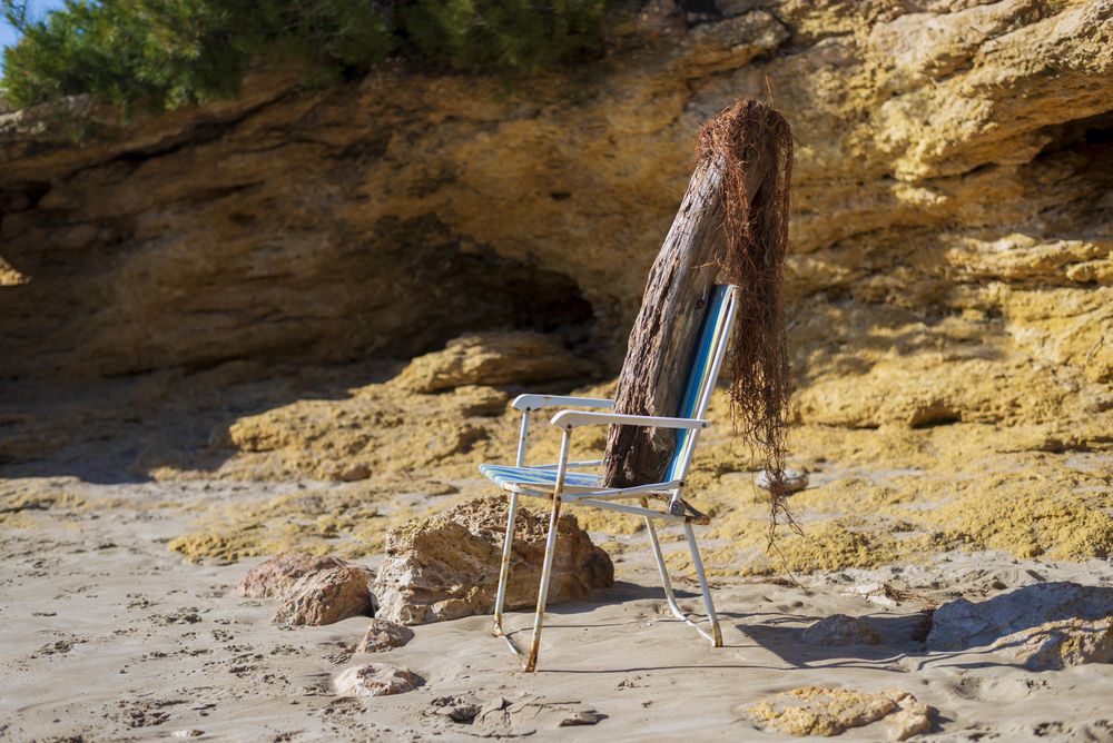Beach chair with driftwood and net