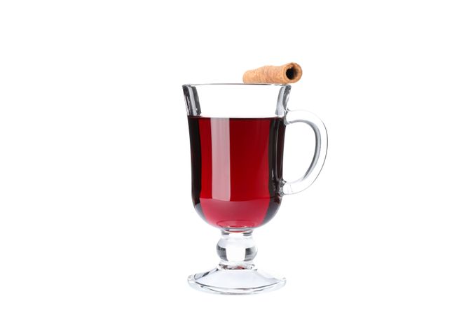 Glass of tasty mulled wine isolated on studio background