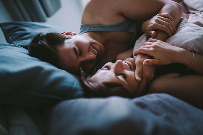 Young man tenderly holding young woman’s face in an embrace