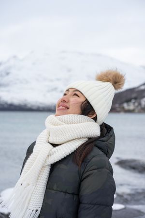 Joyful young woman in warm clothes