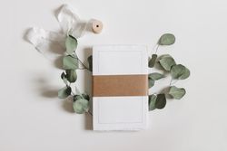 Cotton paper diary with rough edges, craft belly band, tape isolated on table