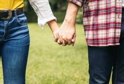 Interracial couple taking a walk hand in hand in the park