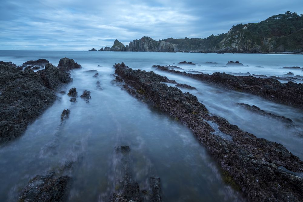 Foggy landscape of Playa de Gueirua rock seashore
