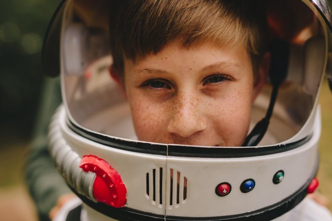 Boy playing astronaut with space helmet