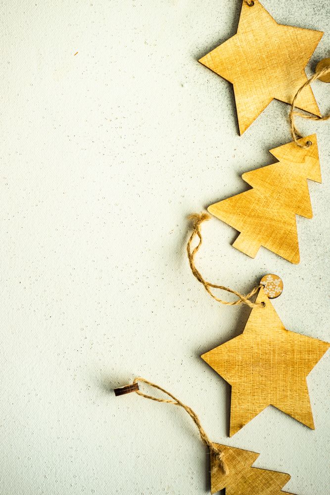 Close up of tree and star Christmas ornaments on marble counter