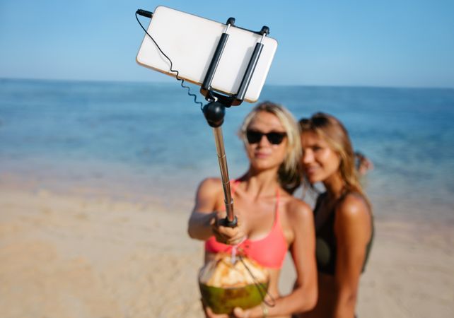 Women friends on beach holiday taking selfie
