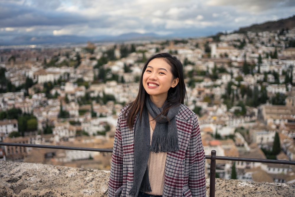 Cheerful woman visiting ancient city
