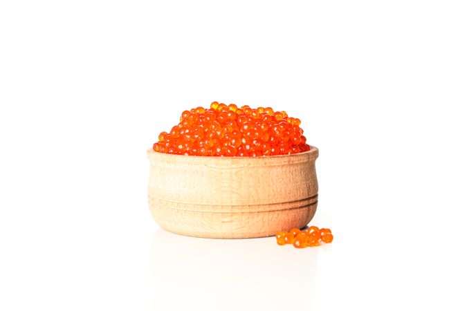 Wooden bowl with caviar isolated on plain background