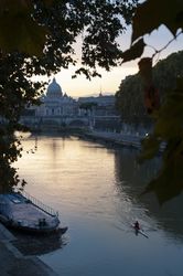 Person floating on boat towards bridge