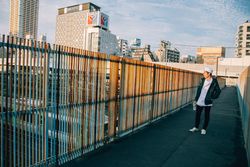 Man wearing chef hat outdoor looking at city view