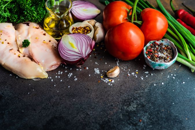 Chicken breasts & vegetables ready for dinner prep on counter with copy space