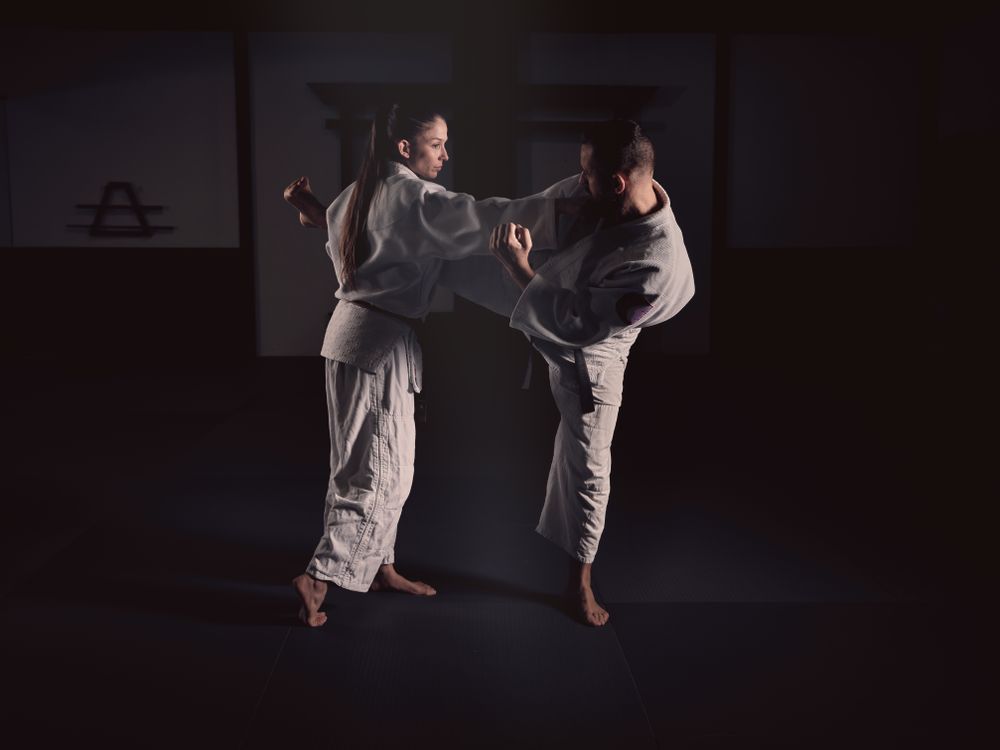 Man kicking woman during Krav Maga training