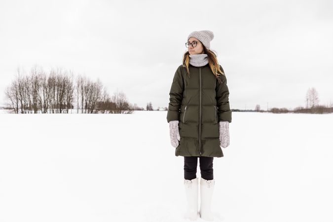 Young woman in winter wear on snow field