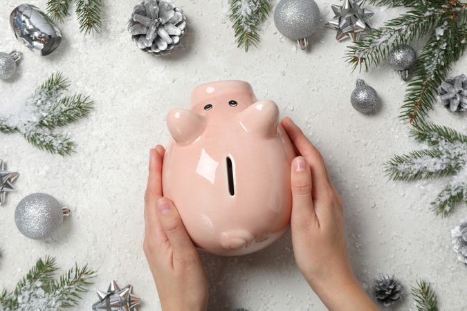 Concept of Christmas finance with piggy bank, top view